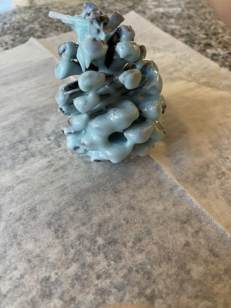 pinecone covered in light blue wax