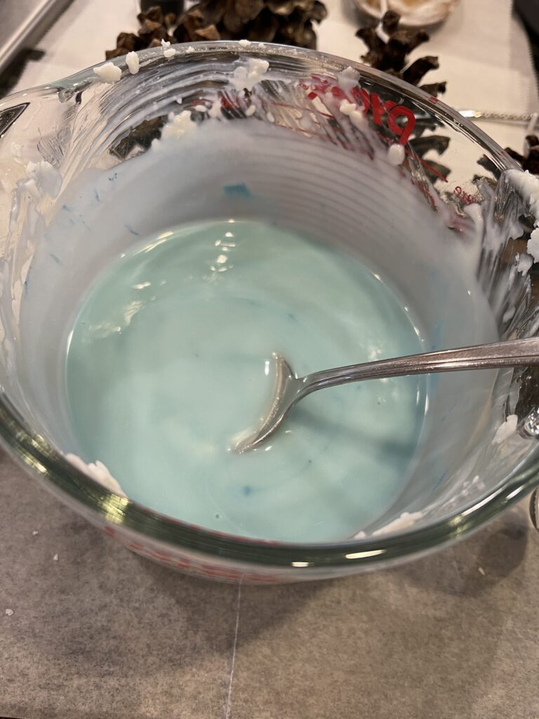 bowl of light blue colored melted wax
